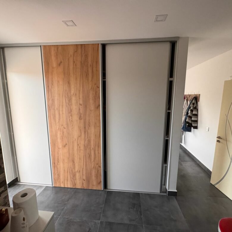 Invest in Ulcinj: Modern room with gray tiles, stone wall, sleek wardrobe, yellow door. Exclusive by Ekosphere DOO at immorenta.me.