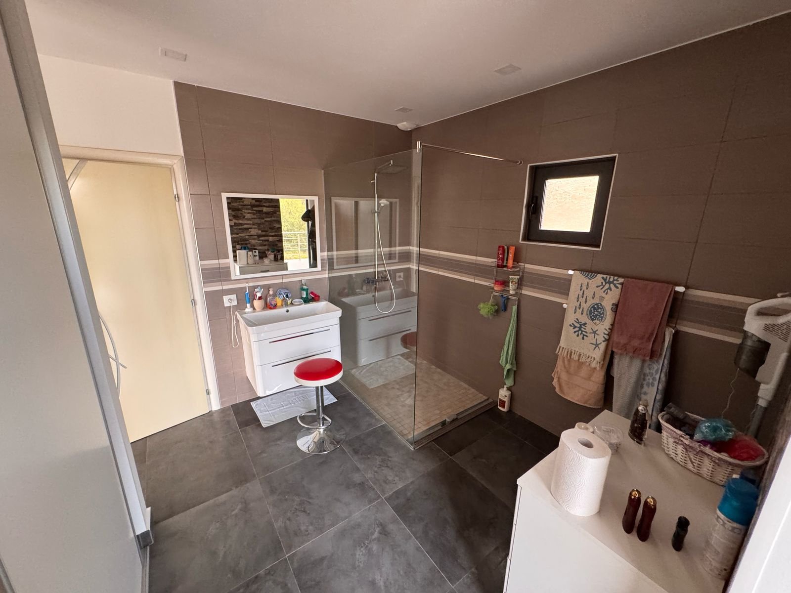 Elegant modern bathroom in Ulcinj with gray tile, glass shower, stylish vanity&mdash;exclusive at immorenta.me by ekosphere doo.