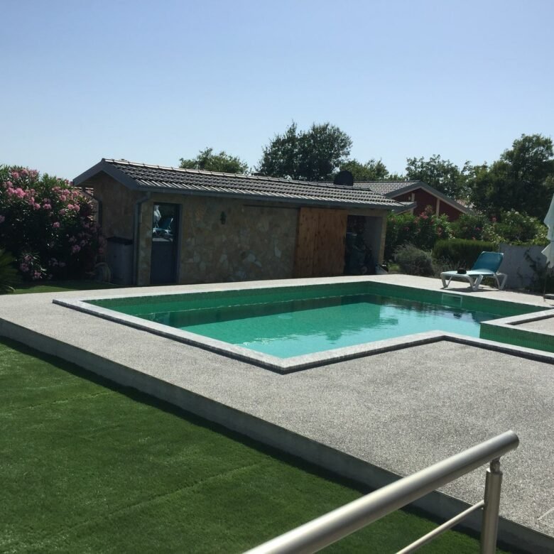 Modern rectangular pool, concrete deck, lounge chairs, pool house&mdash;luxury Ulcinj real estate by immorenta.me/ekosphere doo.