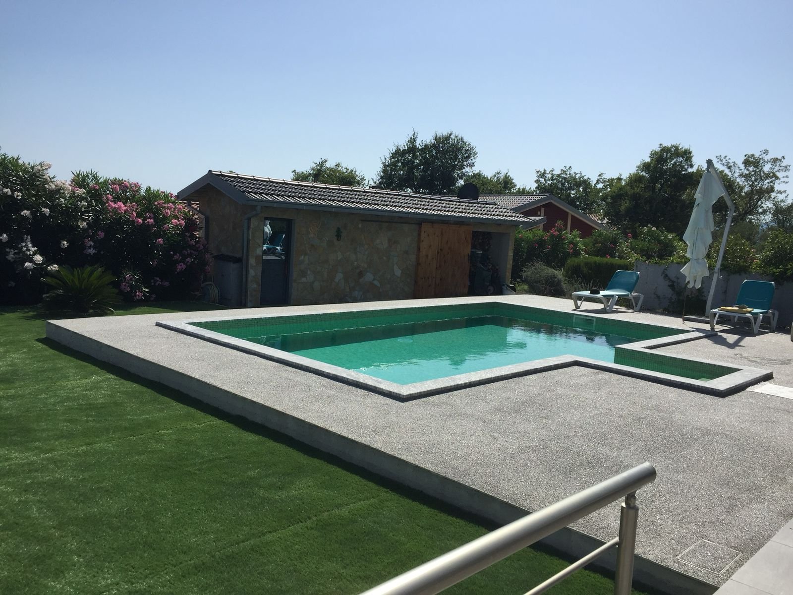 Modern rectangular pool, concrete deck, lounge chairs, pool house&mdash;luxury Ulcinj real estate by immorenta.me/ekosphere doo.