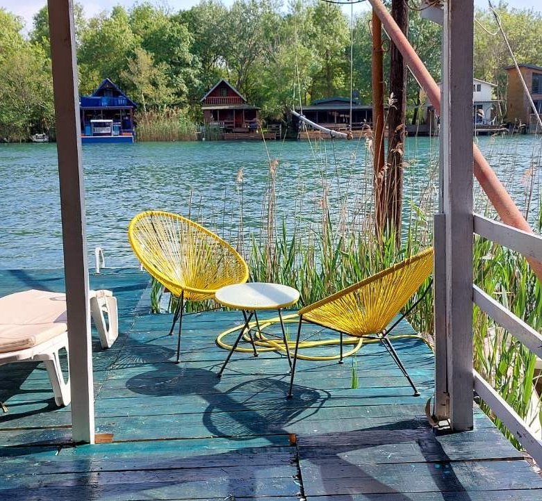 Stunning riverside deck in Ulcinj, Montenegro with yellow chairs and serene river views&mdash;exclusive on immorenta.me by Ekosphere doo.