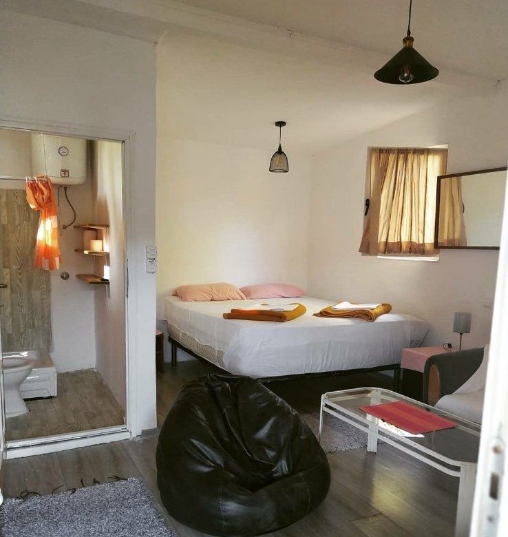 Bright Ulcinj bedroom with double bed, wood floors, and bath access&mdash;ideal Montenegro property by Ekosphere on immorenta.me.