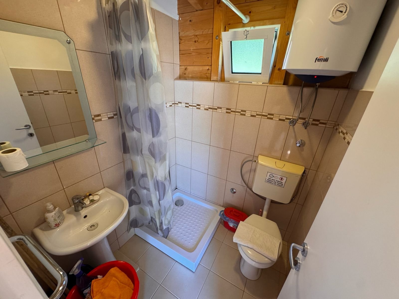 Modern eco-friendly Ulcinj bathroom with corner shower, beige tiles, quality fixtures. Invest in Montenegro at immorenta.me.