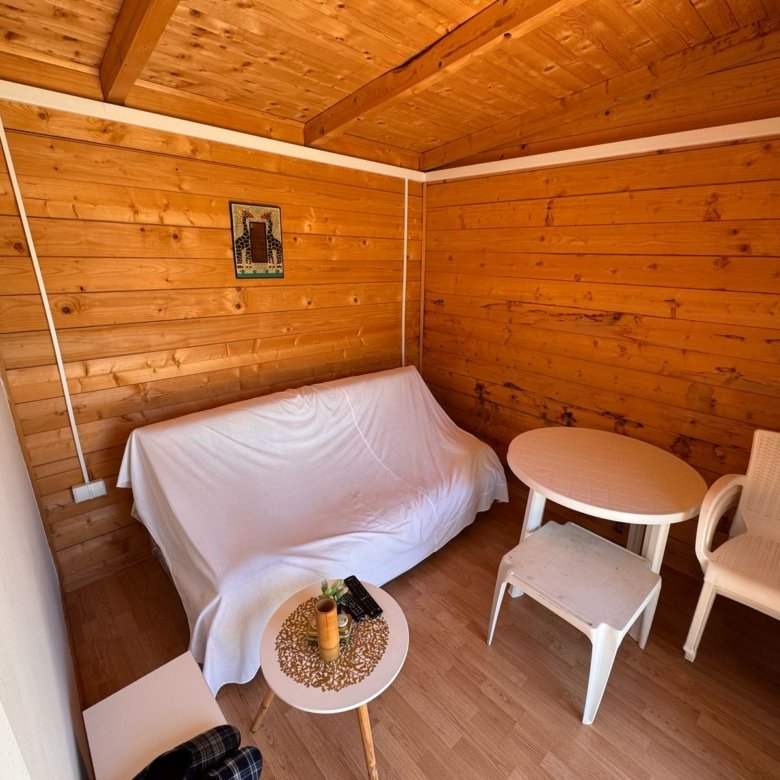 Charming Ulcinj property for sale: sunlit wooden room, stylish furnishings, exclusive on immorenta.me by Ekosphere DOO.