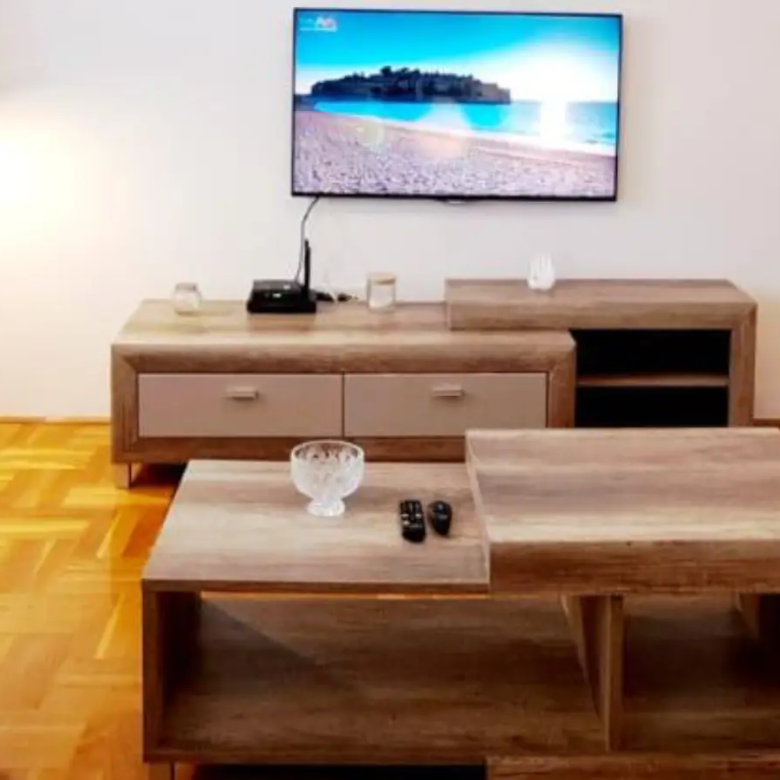 Stunning Ulcinj Montenegro property: modern living room, sleek TV, stylish wood accents, ideal investment by ekosphere doo on immorenta.me.