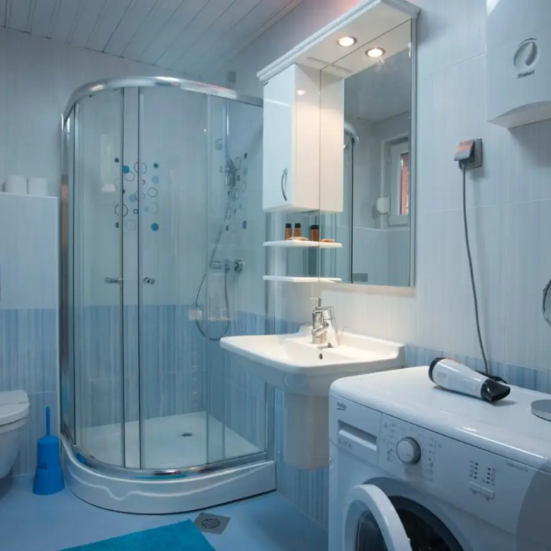Contemporary Ulcinj bathroom: glass shower, modern fixtures, washing machine. Invest in Montenegro with immorenta.me by ekosphere doo.