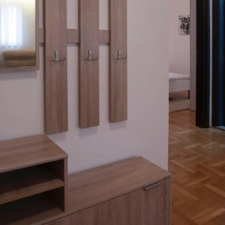 Elegant Ulcinj hallway with parquet floors, mirror, storage&mdash;ideal for property investment. Explore at immorenta.me by ekosphere doo.