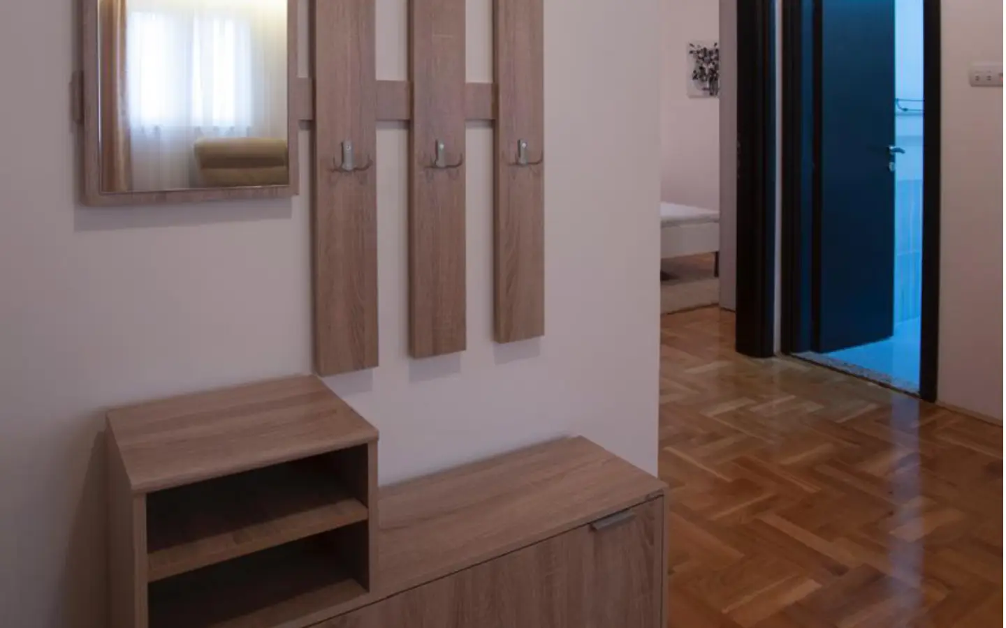 Elegant Ulcinj hallway with parquet floors, mirror, storage&mdash;ideal for property investment. Explore at immorenta.me by ekosphere doo.