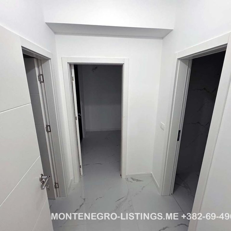 Spacious white hallway with 3 open doorways, marble floors&mdash;prime Ulcinj real estate by immorenta.me, ekosphere doo.