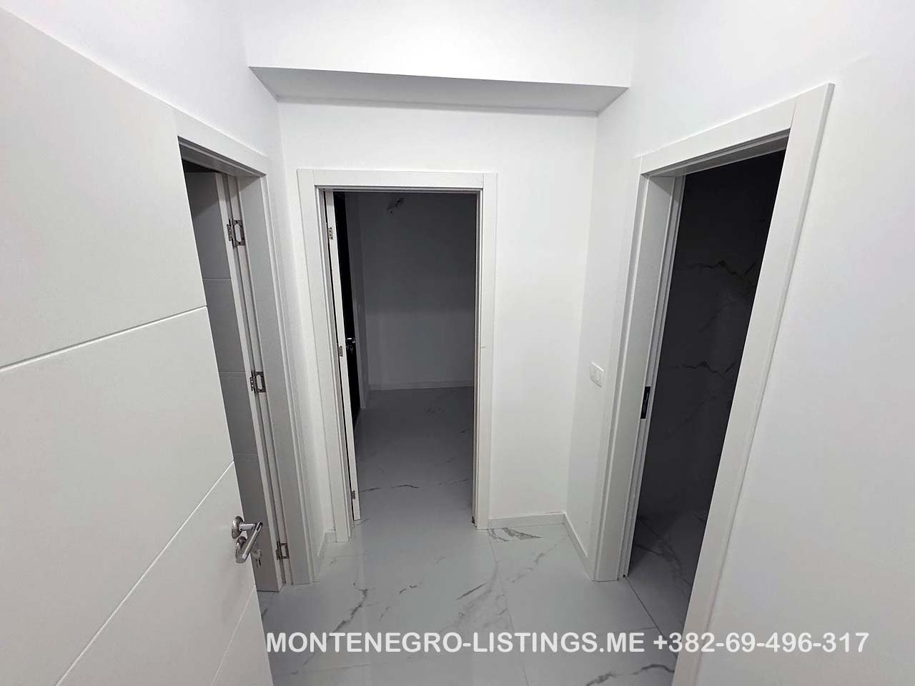 Spacious white hallway with 3 open doorways, marble floors&mdash;prime Ulcinj real estate by immorenta.me, ekosphere doo.