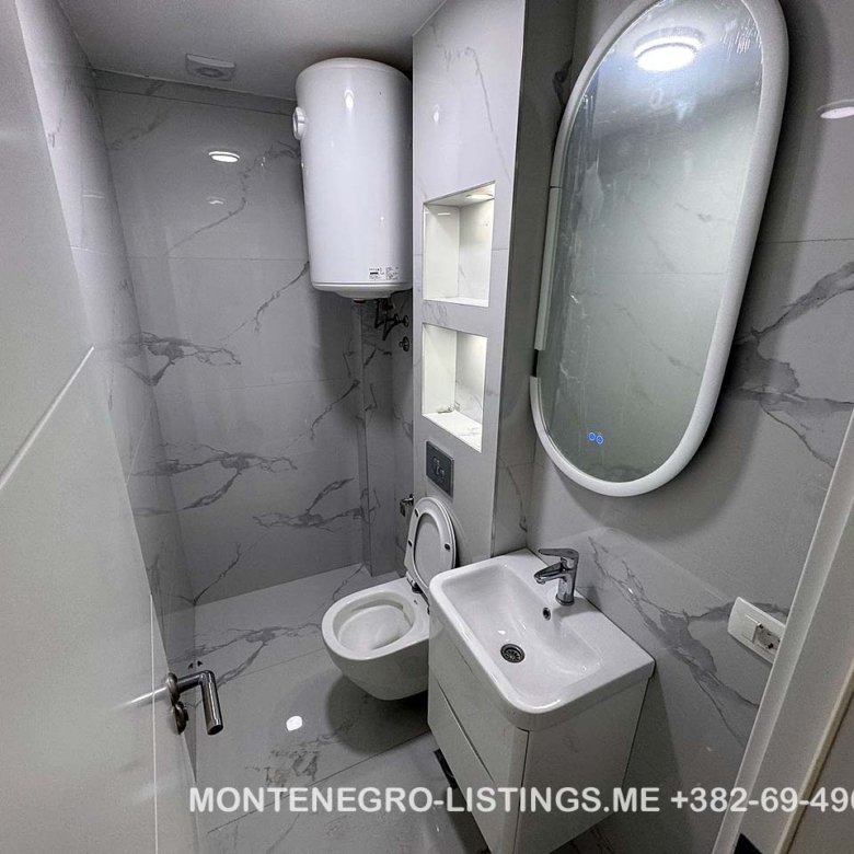 Modern bathroom with sink and toilet, ideal for Ulcinj property investment. On immorenta.me by ekosphere doo.