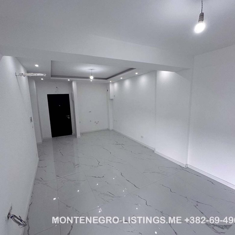 Stunning modern white space with glossy floors and recessed lights&mdash;perfect Ulcinj, Montenegro real estate. immorenta.me by Ekosphere doo.