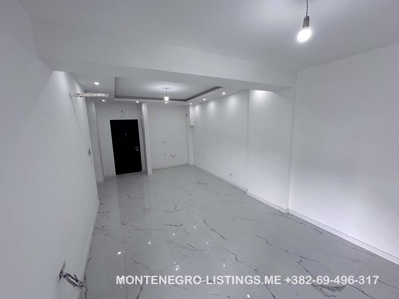 Stunning modern white space with glossy floors and recessed lights&mdash;perfect Ulcinj, Montenegro real estate. immorenta.me by Ekosphere doo.