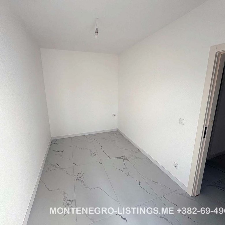 Bright, modern room with white walls and marble tiles in Ulcinj&mdash;prime real estate investment from immorenta.me by Ekosphere doo.