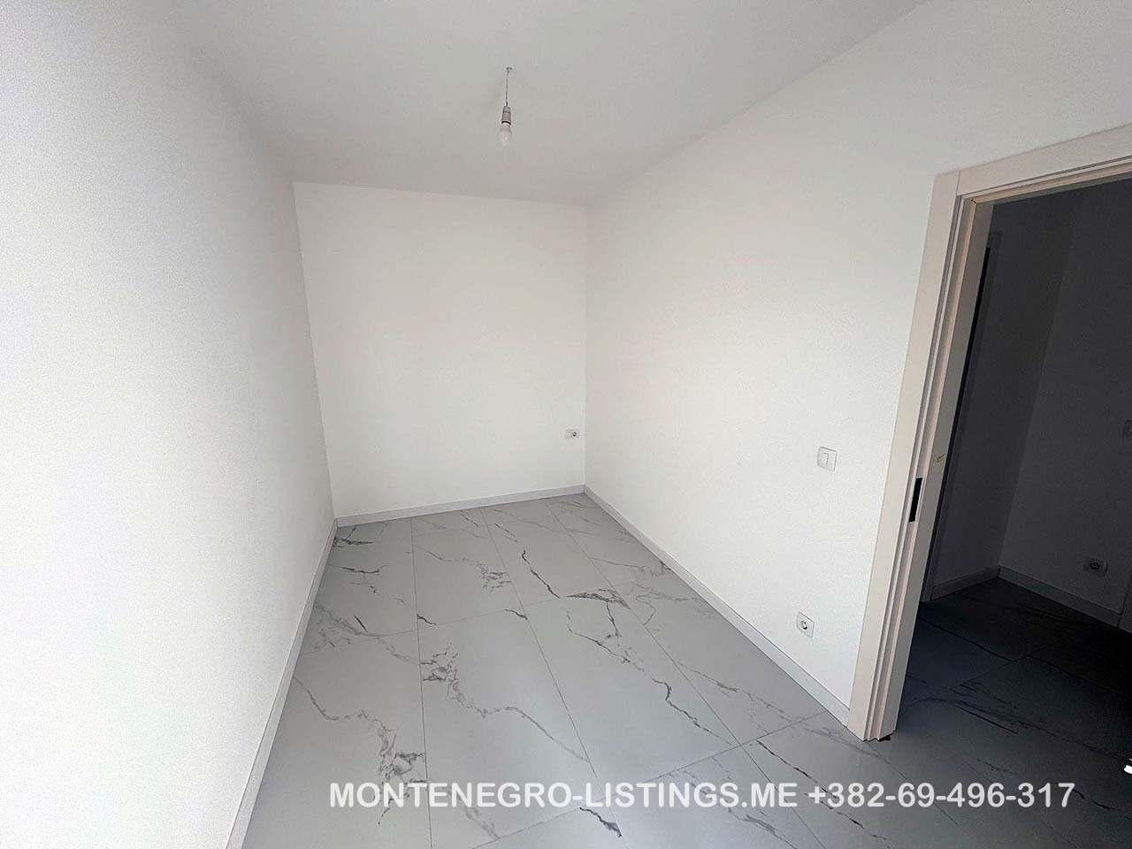 Bright, modern room with white walls and marble tiles in Ulcinj&mdash;prime real estate investment from immorenta.me by Ekosphere doo.