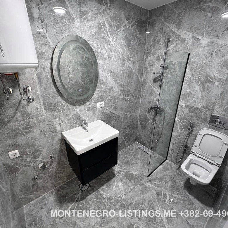 Luxurious Ulcinj bathroom with marble tiles, premium fixtures&mdash;ideal Montenegro property investment via immorenta.me by ekosphere doo.