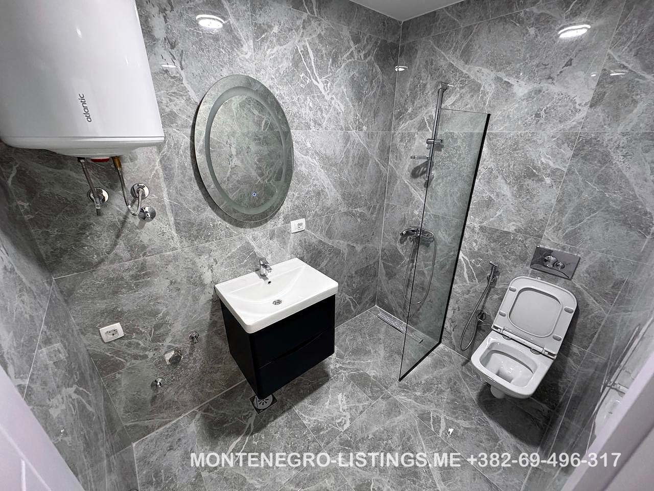 Luxurious Ulcinj bathroom with marble tiles, premium fixtures&mdash;ideal Montenegro property investment via immorenta.me by ekosphere doo.