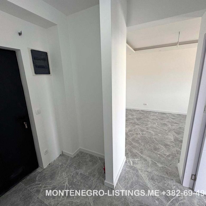 Contemporary interior in Ulcinj: gray tiled floors, white walls, bright open space. Invest with immorenta.me by ekosphere doo.