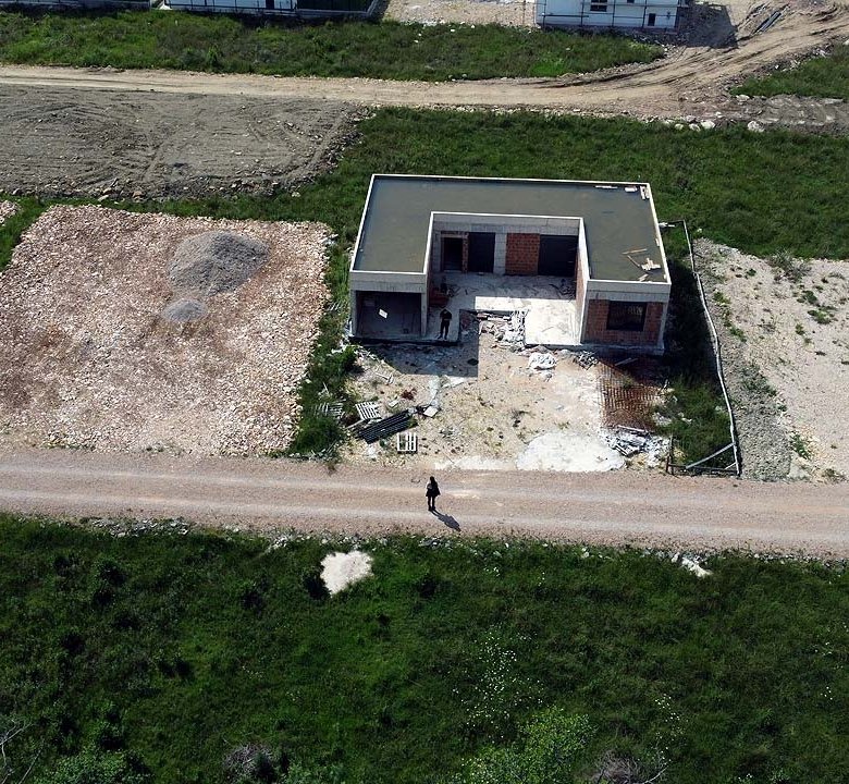 Prime investment opportunity: aerial of unfinished house on spacious Ulcinj lot, great ROI. Montenegro-Listings.me by Ekosphere DOO.