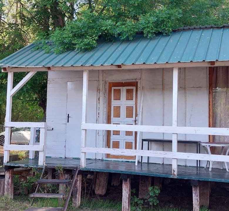 Eco-friendly wooden cabin with green roof and white features on raised deck; prime Ulcinj real estate by immorenta.me/Ekosphere.