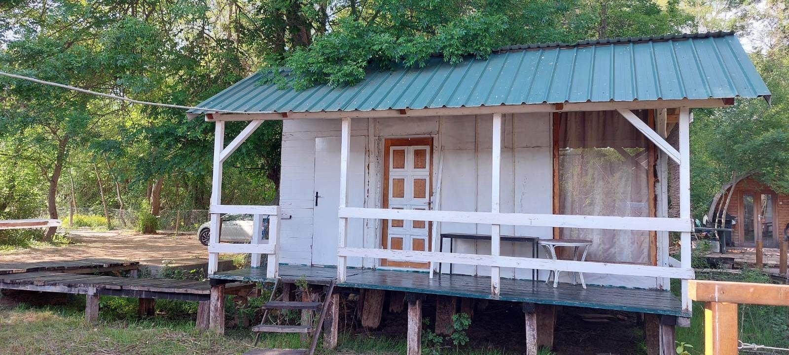 Eco-friendly wooden cabin with green roof and white features on raised deck; prime Ulcinj real estate by immorenta.me/Ekosphere.