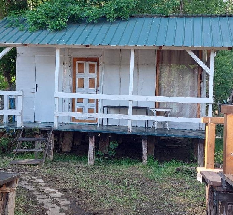 Charming white wooden cabin on stilts with green metal roof, porch, and parking in Ulcinj&mdash;prime real estate by immorenta.me.
