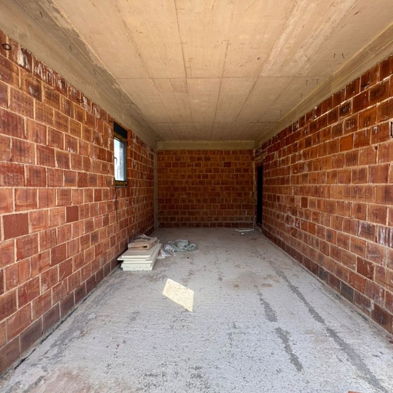 Spacious unfinished brick room with concrete floor, window, prime Ulcinj real estate&mdash;investment via immorenta.me by ekosphere doo.