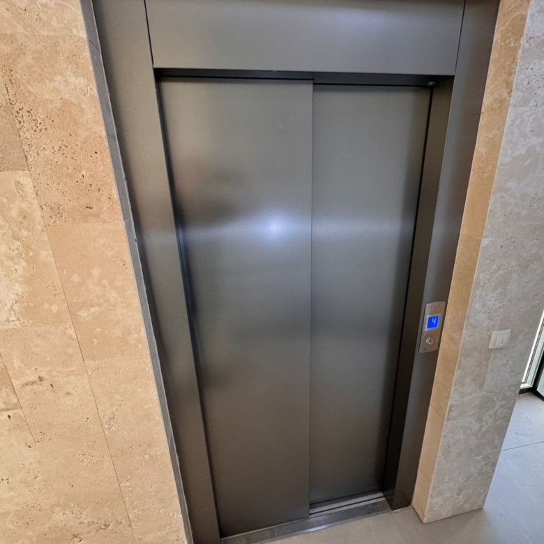 Modern stainless steel elevator, stone corridor, and premium amenities in Ulcinj real estate. Invest at immorenta.me by ekosphere doo.