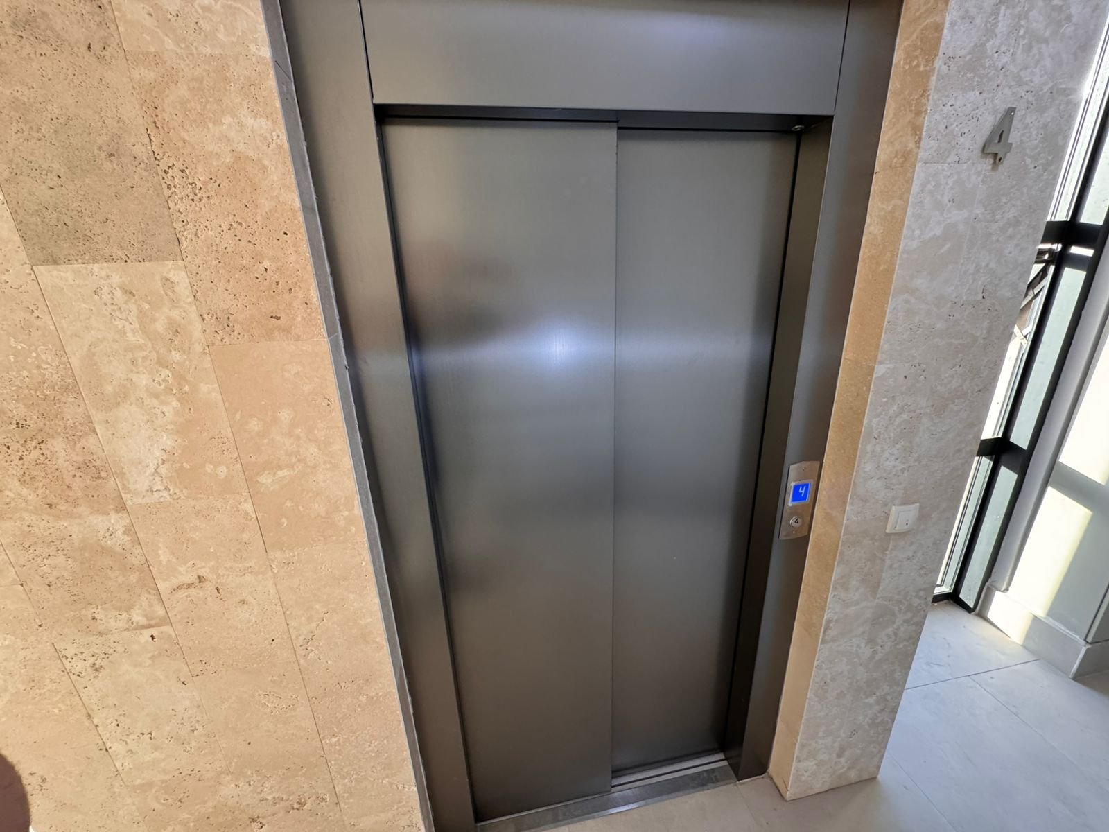 Modern stainless steel elevator, stone corridor, and premium amenities in Ulcinj real estate. Invest at immorenta.me by ekosphere doo.