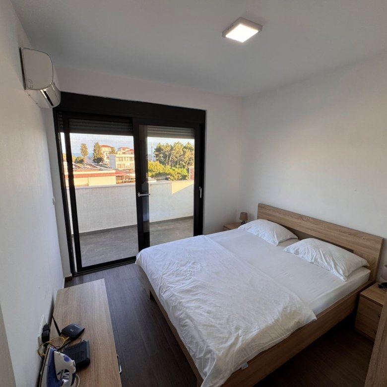 Luxurious Ulcinj Montenegro bedroom with double bed, AC, elegant wood d&eacute;cor & balcony views&mdash;exclusive on immorenta.me by ekosphere doo.