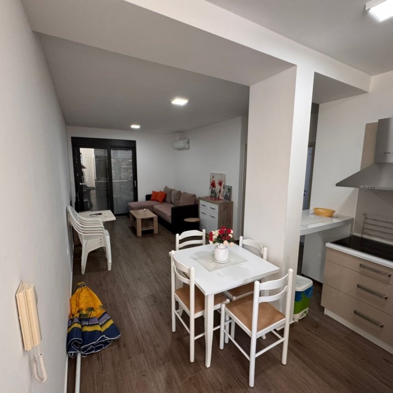 Stylish Ulcinj apartment for sale: modern open kitchen, dining area, bright living space by sliding doors&mdash;on immorenta.me by Ekosphere.