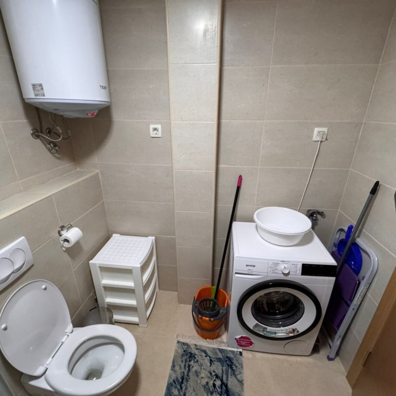 Modern bathroom in Ulcinj real estate: toilet, washing machine, water heater. Quality Ekosphere tiling. Montenegro-listings.me exclusives.