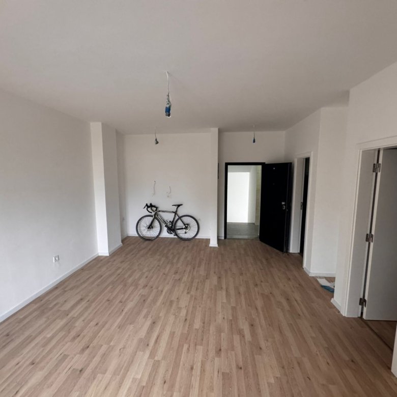 Bright, unfurnished Ulcinj room with sleek wood floors, white walls; flexible investment via immorenta.me by Ekosphere.