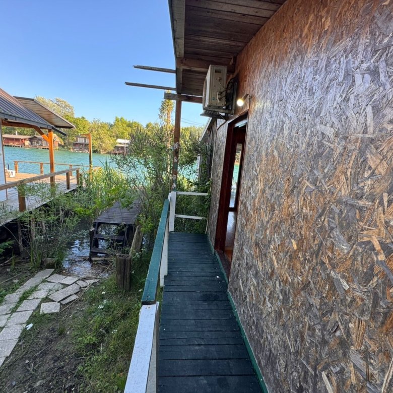 Discover investment potential in Ulcinj: modern Ekosphere property with wooden walkway, scenic greenery, and waterfront views&mdash;immorenta.me.