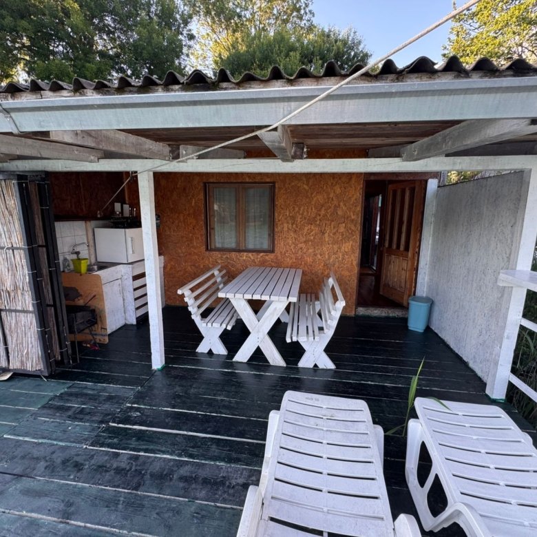 Charming covered patio with elegant white furniture, lounge chairs, and wooden accents&mdash;exclusive Ulcinj real estate by Ekosphere on immorenta.me.