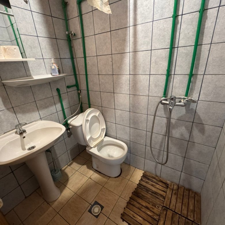 Modern tiled bathroom for sale in Ulcinj, Montenegro&mdash;features sink, shower, and toilet. Exclusive on immorenta.me by ekosphere doo.