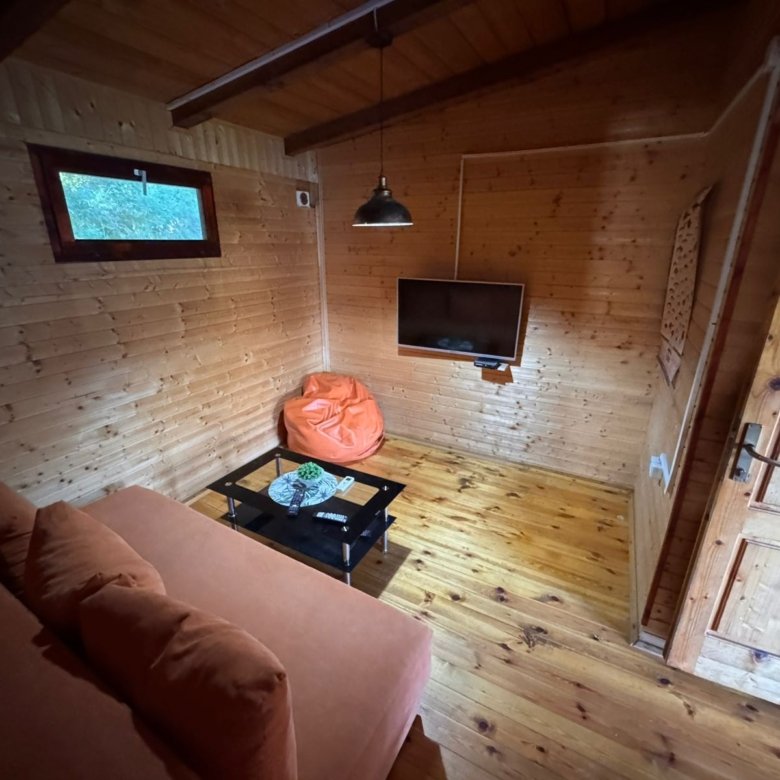 Stylish wooden room in Ulcinj: sofa, coffee table, TV. Unique real estate by ekosphere doo&mdash;find properties on immorenta.me.