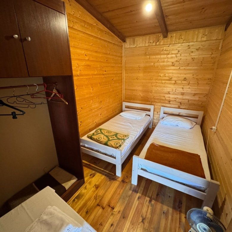 Charming wooden room in Ekosphere&rsquo;s Ulcinj property&mdash;two beds, wardrobe, modern amenities. Exclusive at immorenta.me.
