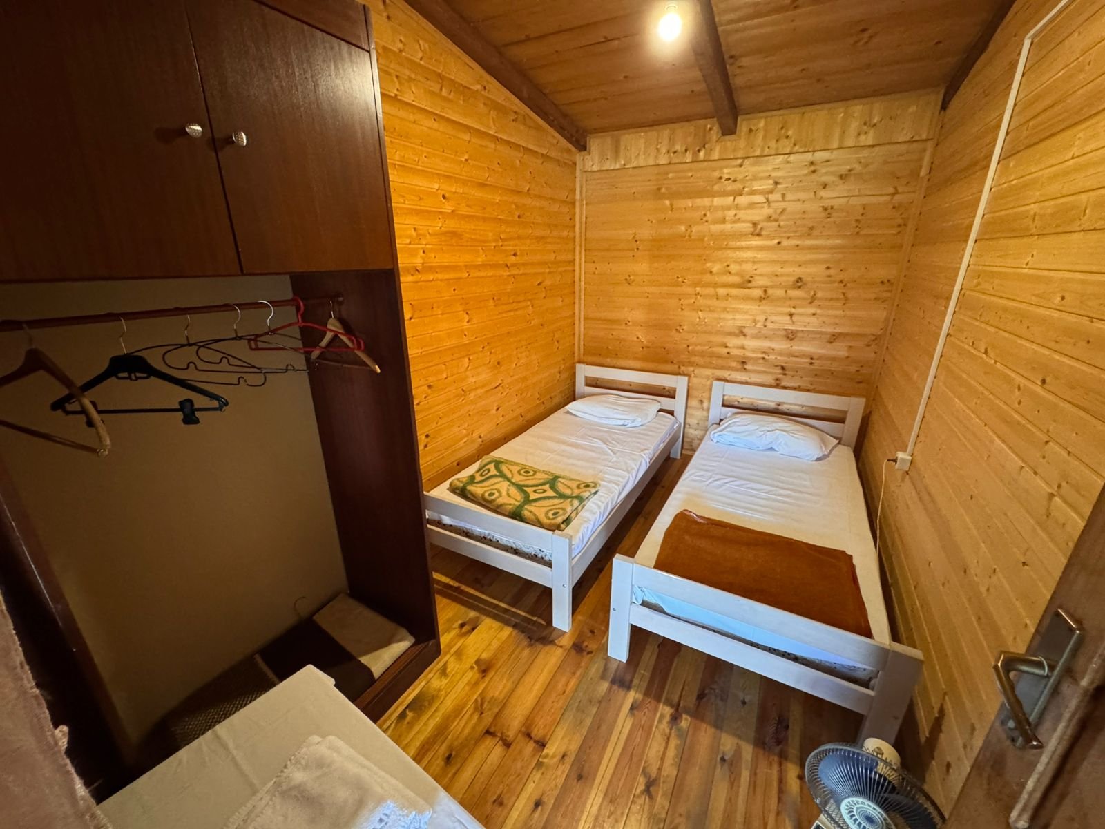Charming wooden room in Ekosphere&rsquo;s Ulcinj property&mdash;two beds, wardrobe, modern amenities. Exclusive at immorenta.me.