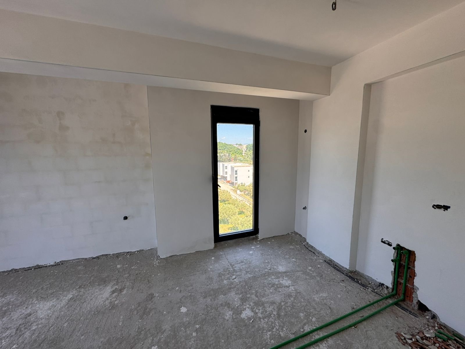 Unfinished Ulcinj property with concrete floors, white walls, and city views&mdash;exclusive on immorenta.me by Ekosphere doo.
