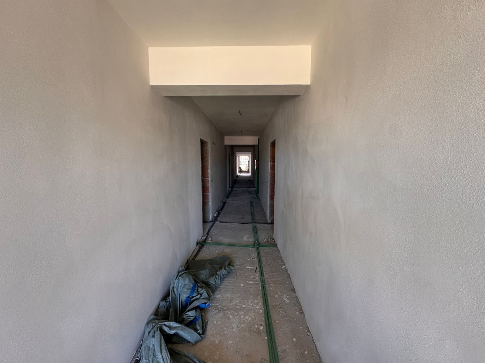 Prime Ulcinj property opportunity&mdash;spacious unfinished hallway, natural light, investment-ready on immorenta.me by ekosphere doo.