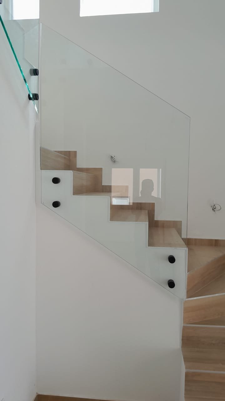 Elegant wooden staircase with glass railing, premium feature in Ulcinj properties. Invest via immorenta.me by Ekosphere doo.