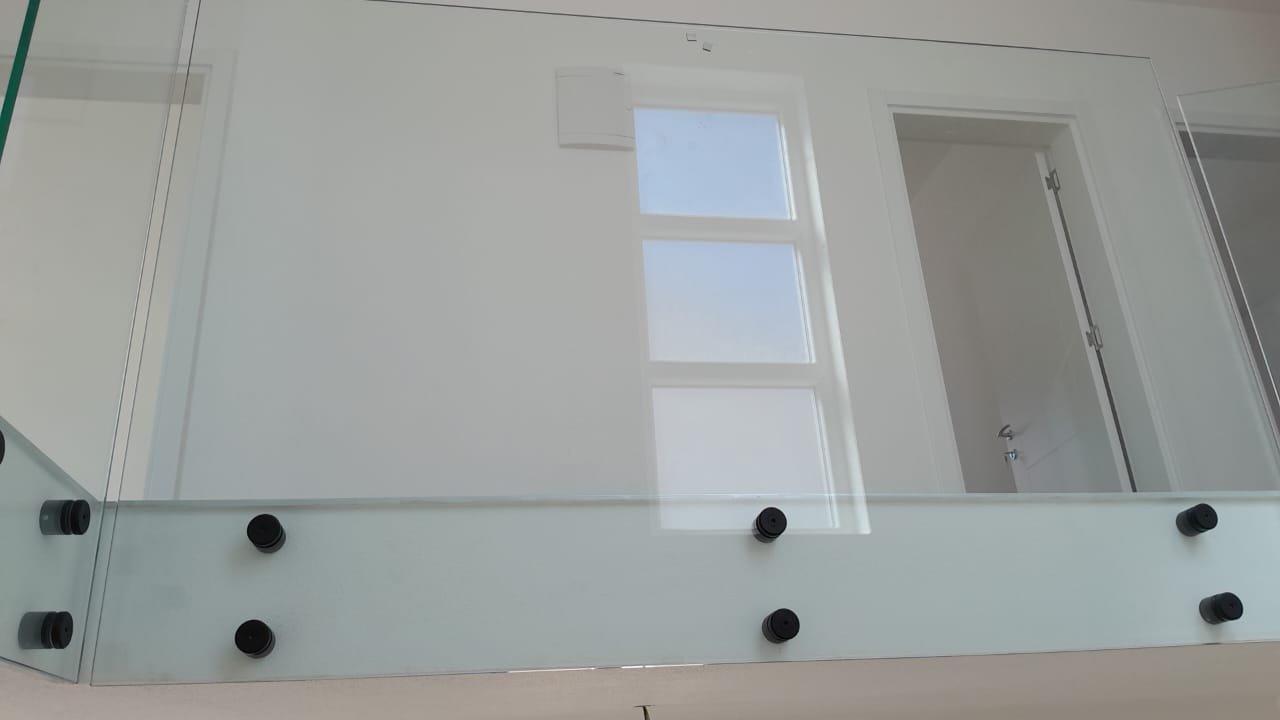 Modern glass railing with black hardware, sleek white wall, door, and window&mdash;ideal Ulcinj investment. Exclusive on immorenta.me by ekosphere doo.