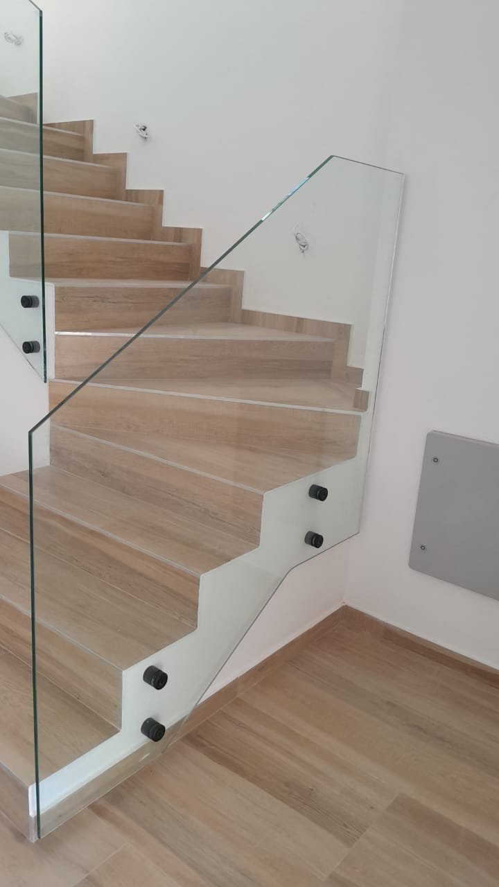Sleek light-wood staircase with glass railings, ideal for luxury Ulcinj real estate. See more at immorenta.me by ekosphere doo.