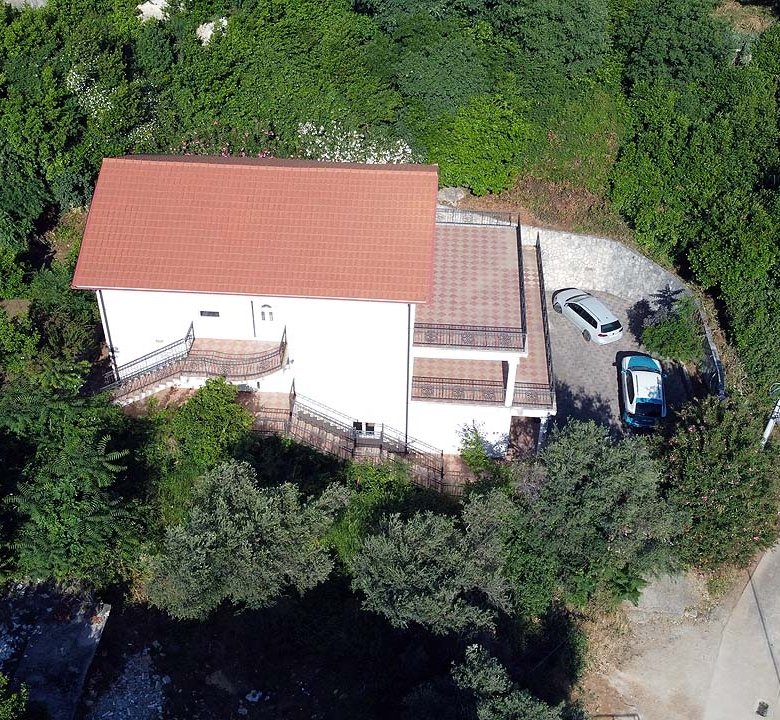 Aerial view of a modern white house with red roof in lush Ulcinj, perfect real estate investment by ekosphere doo, immorenta.me.