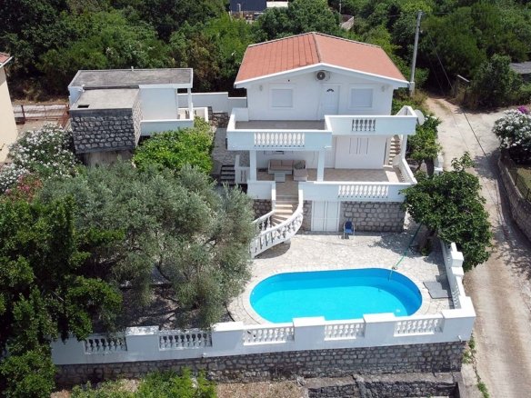 Premium two-story villa in Ulcinj, Montenegro with red roof, balcony, private pool and stone-walled yard. Eksophere doo project.