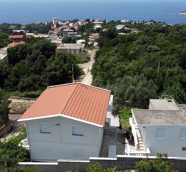 Stunning aerial of white villas with red roofs amid greenery in Ulcinj, Montenegro&mdash;prime investment via immorenta.me by ekosphere doo.