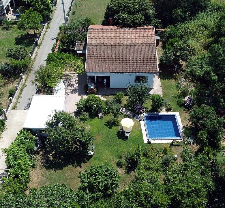 Exclusive Ulcinj property: red-tiled villa with lush garden, pool, and pathways. Top Montenegro real estate&mdash;immorenta.me by ekosphere doo.