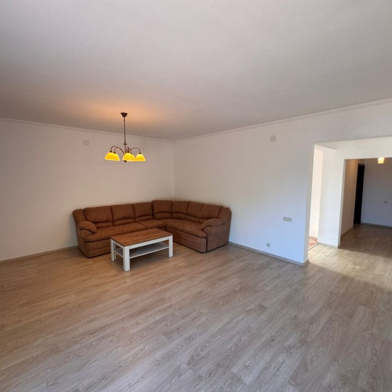 Modern, spacious living room in Ulcinj with light wood floors, stylish furnishings&mdash;ideal Montenegro investment from Ekosphere & immorenta.me.