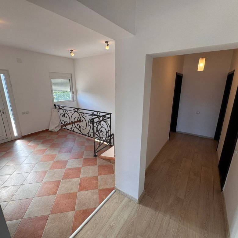 Sunlit entryway with tiled floor, elegant railings, and wood-floored hallway&mdash;prime Ulcinj real estate by immorenta.me/Ekosphere doo.